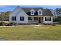 Beautiful house with white siding, black shutters, dormer windows, and a cozy front porch at 1222 Snapping Shoals Rd, Mcdonough, GA 30252