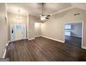 Spacious living area with modern wood flooring, ceiling fan, and a view of the entry at 596 Carlton Rd, Palmetto, GA 30268