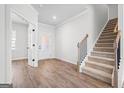Bright foyer features wood-look floors, a staircase, and an entry to the office space at 1619 Tide Mill Rd, Cumming, GA 30040