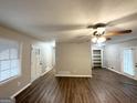 Spacious living room features a ceiling fan and hardwood flooring throughout at 6635 Hidden Brook Trl, South Fulton, GA 30349