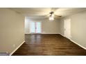 Bright living room with hardwood floors and natural light from the French doors at 6635 Hidden Brook Trl, South Fulton, GA 30349