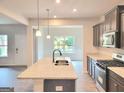Stylish kitchen with granite countertops, stainless steel appliances and modern fixtures at 4841 Walkers Green, Mableton, GA 30126