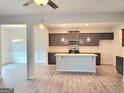 Open-concept kitchen with stainless steel appliances and a center island at 4841 Walkers Green, Mableton, GA 30126