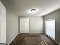 Bright bedroom features carpeted floors, a window with blinds, and a double door closet at 120 Gran De, Atlanta, GA 30349
