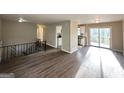 Spacious living room with wood floors, access to the kitchen, and sliding doors to a deck at 2786 Altaview Se Dr, Atlanta, GA 30354