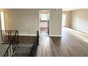 Open concept living area featuring wood floors, stairs to a lower level, and a view into the kitchen at 2786 Altaview Se Dr, Atlanta, GA 30354