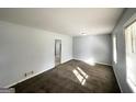 Cozy living room features carpet, light fixture, and sun-lit windows, providing a welcoming space at 2087 John Wesley Ct, Decatur, GA 30035