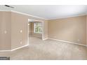 A spacious living room featuring neutral walls and plush carpeting at 10018 Clearwater Trl, Jonesboro, GA 30238