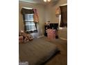 Bedroom featuring carpet floors, a bed, and a window with curtains at 104 14Th St, Cumming, GA 30040