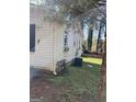 Side yard with a partial view of the home's exterior and an air conditioning unit at 104 14Th St, Cumming, GA 30040