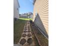 Landscaped backyard path with stone pavers between homes, offering a private and tranquil walkway at 3620 Pickeral St, Fairburn, GA 30213