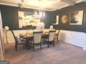 Elegant dining room featuring stylish decor, dark accent wall, and ample seating for gatherings at 3620 Pickeral St, Fairburn, GA 30213