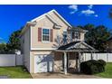 Two-story home features red window shutters, a fenced yard, and an attached garage at 312 Silver Fox Trl, Dallas, GA 30157