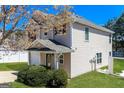 Charming two-story home featuring a well-maintained lawn, manicured bushes, and inviting architecture at 312 Silver Fox Trl, Dallas, GA 30157