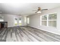 Spacious living room boasting modern gray floors, double doors, and ample natural light at 312 Silver Fox Trl, Dallas, GA 30157