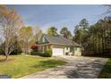 Home with a well-manicured lawn and a concrete driveway leading to an attached two-car garage at 50 Clear Spring Ct, Oxford, GA 30054