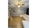 Open living room featuring hardwood floors, a comfortable sectional sofa, and neutral wall colors at 2900 Haddon Dr, Rex, GA 30273