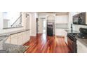 The kitchen is equipped with stainless steel appliances, granite countertops, and white cabinetry at 1209 Richmond Rdg, Loganville, GA 30052