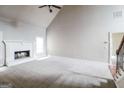 Bright living room features a ceiling fan, a cozy fireplace, and access to the staircase at 1209 Richmond Rdg, Loganville, GA 30052