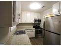 Bright kitchen with stainless steel appliances and updated countertops at 5960 John St, Austell, GA 30106