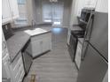 Modern kitchen with stainless steel appliances, light countertops, and ample cabinet space at 1742 Pine Fort Cir, Dacula, GA 30019
