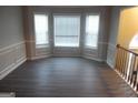 Bright living room with decorative trim, sleek flooring, and large windows for natural light at 1742 Pine Fort Cir, Dacula, GA 30019
