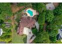 An aerial view of a luxurious property featuring a pool, landscaped grounds, and a sprawling residence at 157 Glen Eagle Way, Mcdonough, GA 30253