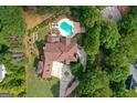An aerial view of a luxurious property featuring a pool, landscaped grounds, and a sprawling residence at 157 Glen Eagle Way, Mcdonough, GA 30253