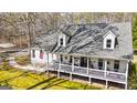 Inviting two-story house with a spacious front porch and dormer windows at 313 Dingler Rd, Moreland, GA 30259