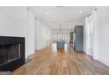 Spacious living room with fireplace, hardwood floors, and an open layout at 434 Selborne Way, Chattahoochee Hills, GA 30268
