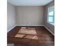 A well-lit living room featuring hardwood floors and neutral wall colors at 6521 King William Dr, Morrow, GA 30260