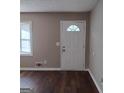 Sunlit living room with hardwood floors, neutrally painted walls, and an entryway at 6521 King William Dr, Morrow, GA 30260