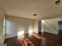 Bright living room with hardwood flooring, neutral walls, and staircase access at 1857 Oak Hill Springs Blvd, Lithonia, GA 30058