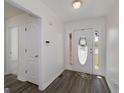 Bright entryway featuring a decorative door and hardwood-style floors at 249 Edenwylde Ct, Hampton, GA 30228