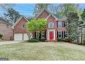 Beautiful brick home with black shutters, a two-car garage, and a well-maintained front lawn at 10460 Cranchester Way, Alpharetta, GA 30022