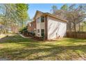Exterior view of brick home with siding, manicured lawn, and mature trees at 110 Windsor Hts, Fayetteville, GA 30215