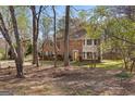 Traditional brick home with mature trees, a swing set, and a view of the front yard at 110 Windsor Hts, Fayetteville, GA 30215