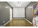 A simple room with neutral walls, concrete flooring, a chandelier, and modern art at 803 Bentley Hill Rd, Stockbridge, GA 30281