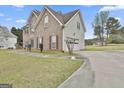 Angle view of brick home, featuring a garage and a concrete driveway at 198 Crestwood Rd, Tyrone, GA 30290