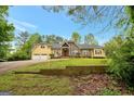 Spacious home featuring a two-car garage, a mix of brick and siding, and a neatly landscaped front yard at 4050 Old Fairburn Rd, Atlanta, GA 30349