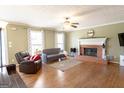 Inviting living room featuring a cozy fireplace, hardwood floors, and ample natural light at 500 Hayfield Ct, Locust Grove, GA 30248
