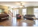 Spacious living room with hardwood floors, staircase, and abundant natural light at 500 Hayfield Ct, Locust Grove, GA 30248
