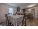 Bright dining area with a table set for a meal adjacent to the open kitchen at 133 Springer Rd, Whitesburg, GA 30185
