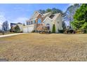 View of the side of the house featuring a well maintained lawn and landscaping at 119 Brookgrove Ln, Peachtree City, GA 30269