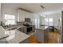 Bright kitchen with granite counters, stainless steel appliances, and an island at 2032 Stonewick Ct, Lawrenceville, GA 30043