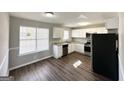 Modern kitchen with white cabinets, stainless steel appliances, and granite countertops at 173 Regency Park Dr, Mcdonough, GA 30253