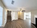 Spacious living area featuring hard surface floors, staircase, and ceiling fan at 371 Coral Cir, Mcdonough, GA 30253
