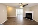 Open living room with fireplace, ceiling fan, and hard surface flooring throughout at 371 Coral Cir, Mcdonough, GA 30253