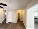 This open living room has hard surface flooring, stairs, and leads to the kitchen at 371 Coral Cir, Mcdonough, GA 30253
