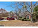 Lovely one-story home with brick and siding, a front yard, and a two-car garage at 2636 General Lee Ct, Buford, GA 30519